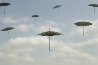 Bir grup siyah şemsiye bulutların arasında gökyüzünde uçuyor.