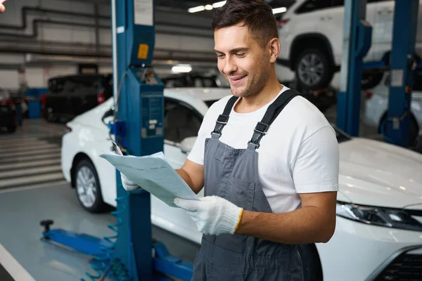 Portrait Mechanic Protective Clothes Gloves Standing Garage Car Holding Documents — Stock Photo, Image