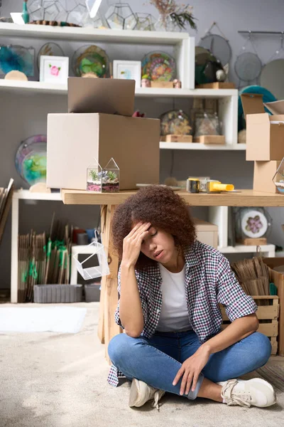 stock image Female is sitting on floor feeling exhausted after packing decorationg for delling online with delivery