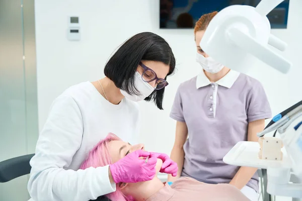 Γυναίκα Γιατρός Εξετάζει Έναν Ασθενή Μια Οδοντιατρική Καρέκλα Μια Κοκκινομάλλα — Φωτογραφία Αρχείου