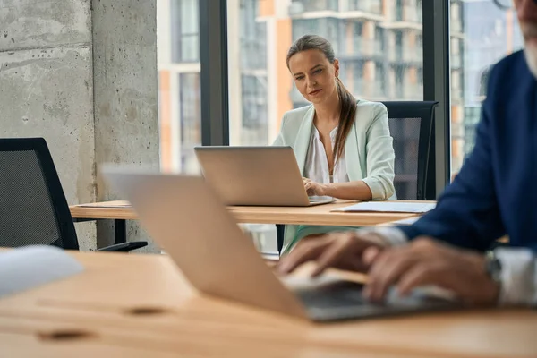 stock image Cropped shot of focused businesslady and her male colleague being focused on work tasks while sharing an office