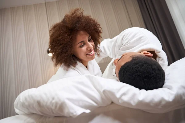 Happy Newlyweds Cuddling Bed Hotel Room Dressed Bathrobes — Foto de Stock