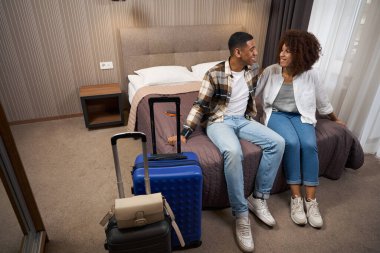 Happy newlyweds arrived at the hotel, around suitcases, bags, passports