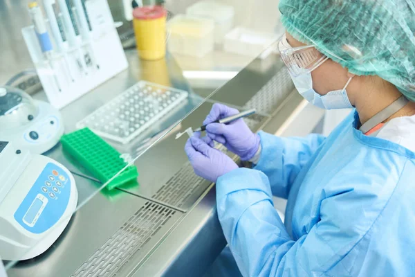 Woman Hematologist Her Desk Marks Test Tubes Biomaterial She Overalls — Stockfoto