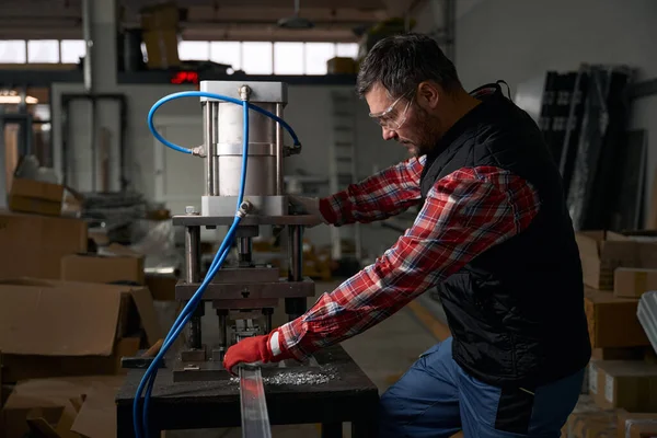 Mężczyzna Okularach Rękawiczkach Ochronnych Wykorzystujący Cylinder Pneumatyczny Obróbki Stalowych Detali — Zdjęcie stockowe