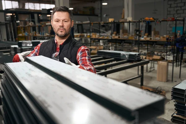 Dorosły Mężczyzna Rękawiczkach Ochronnych Układanie Profilu Stosie Fabryce Konstrukcji Metalowych — Zdjęcie stockowe