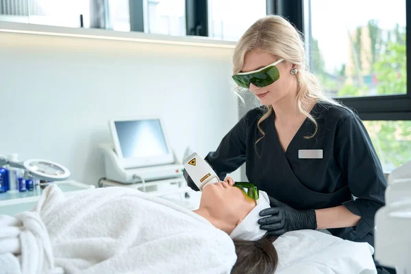 Kosmetikerin Schutzhandschuhen Steht Neben Erwachsener Frau Und Macht Laser Haarentfernung — Stockfoto