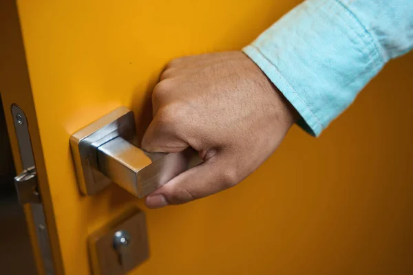 Close Photo Man Holding Metal Handle Opening Yellow Door — Stock Photo, Image