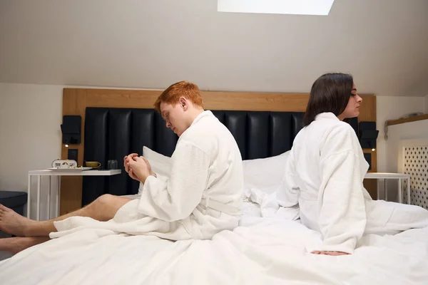 红头发的男人和他的女朋友转过身去 他们正在一家舒适的旅馆里休息 — 图库照片