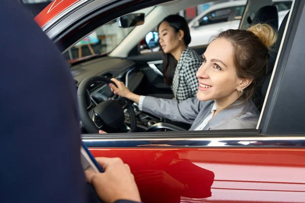 Two Joyful Women Sitting Front Seats Red Car Look Ahead — Stock Photo, Image