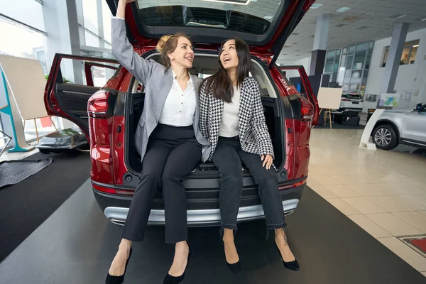 Two Happy Business Ladies Sitting Trunk Red Car — Stock Photo, Image