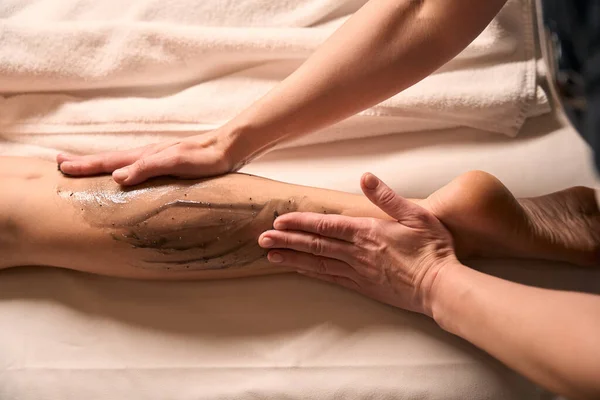 Masörlerin Kadın Müşterinin Bacağını Kahverengi Alg Macunuyla Ovalarken Çekilmiş Bir — Stok fotoğraf