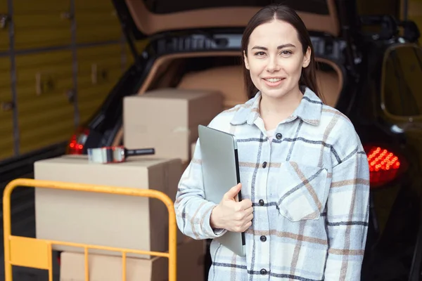 Nice Woman Holding Laptop While Standing Warehouse Truck Load — Stock Photo, Image