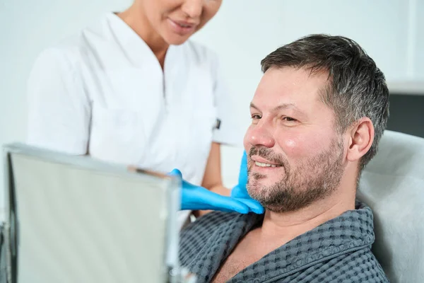 Specialist Cosmetologist Consultation Examines Face Middle Aged Patient Man Looks — Stock Photo, Image