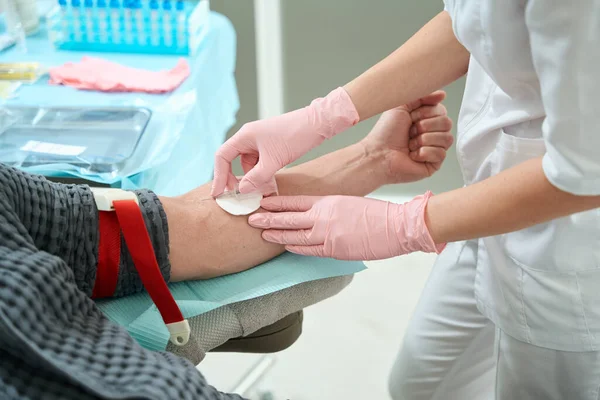 在病人的手臂上放上止血带 从一名男子身上抽取血液 进行进一步恢复活力的纤溶术 — 图库照片
