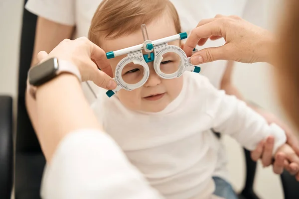 Optometrist Hands Putting Ophthalmic Trial Frame Tranquil Little Patient Mother — Stock Photo, Image