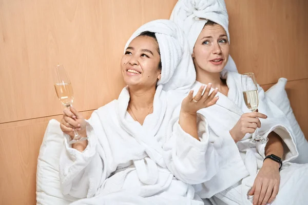 Happy Female Friends Drinking Champagne White Coats Two Ladies Hotel — Stock Photo, Image