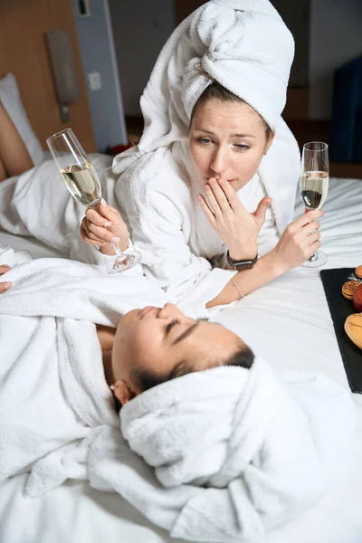 Bornozlu Gözlüklü Meyveli Iki Kadının Bir Otelde Yatakta Konuştuğu Dikey — Stok fotoğraf