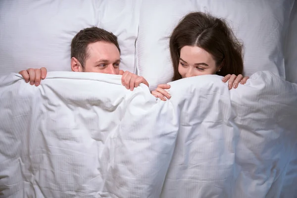 Joyous Male Female Covering Faces Duvet While Looking Each Other — Stock Photo, Image