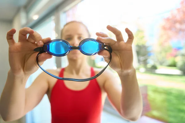 Young Woman Red Swimsuit Standing Window Showing Goggles Pool — Stock Photo, Image