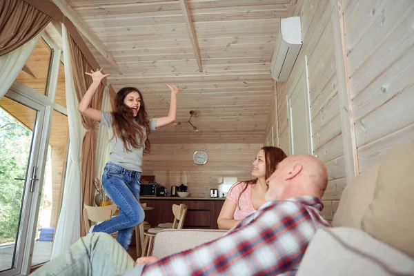 Energetic Adolescent Girl Jumping Air Front Her Father Smiling Mother — Stock Photo, Image