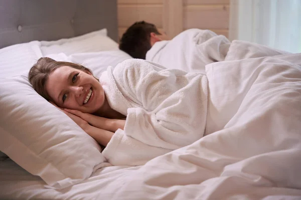 Happy Woman Wearing Bathrobe Laying Pillow White Sheets — Stock Photo, Image