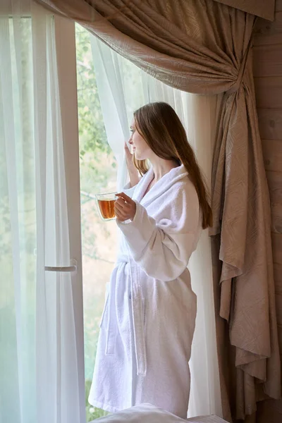Happy Woman Wearing Bathrobe Holding Teacup While Staying Panoramic Window — Stock Photo, Image
