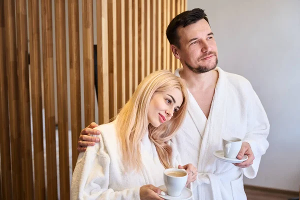Happy Married Couple Standing White Soft Bathrobes Drinking Morning Coffee — Stock Photo, Image