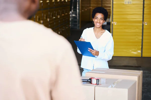 African American Female Taking Inventory Cardboard Boxes Being Deposited Next — Stock Photo, Image