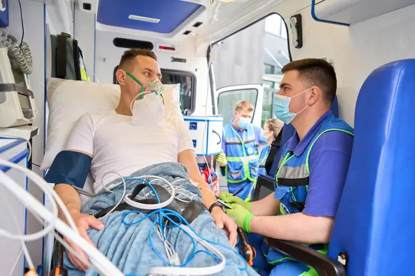 Paramedic Records Patient Responses Ambulance Victim Wearing Oxygen Mask — Stock Photo, Image
