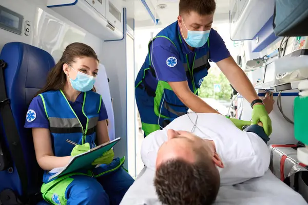 Hulpteam Onderzoekt Snel Patiënt Ambulance Vrouwelijke Arts Voert Een Onderzoek — Stockfoto