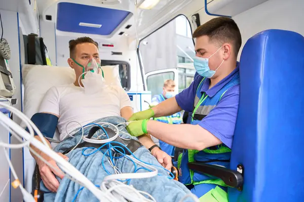Paramedic Administering Medicine Patient Ambulance Injured Person Wearing Oxygen Mask — Stock Photo, Image