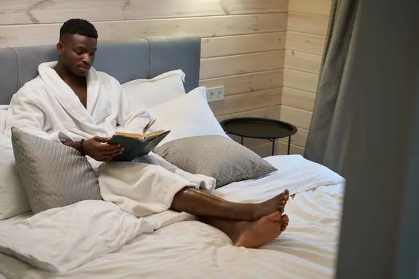 Handsome African American Man Reading Book Cozy Bedroom Seated Large — Stock Photo, Image