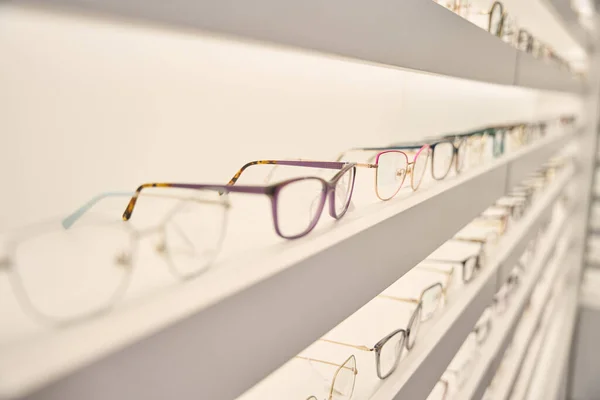 Showcase with a wide selection of eyeglass frames, decorative lighting used