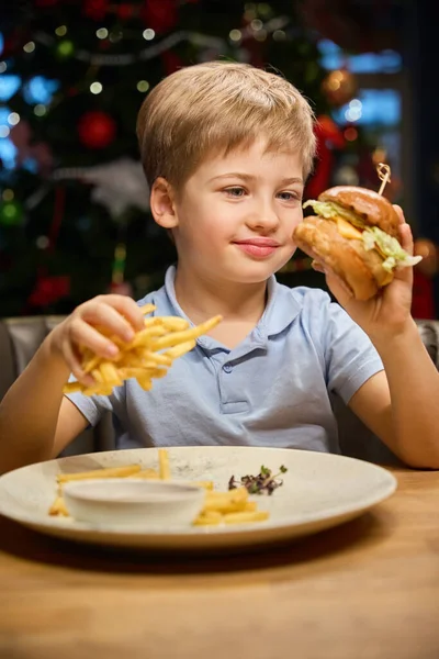 圣诞佳节 快乐的小男孩在舒适的餐厅里享用美味的三明治 — 图库照片