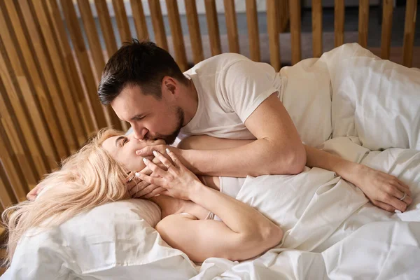Man Gently Kisses His Wife Lips Couple Accommodated Newlyweds Room – stockfoto
