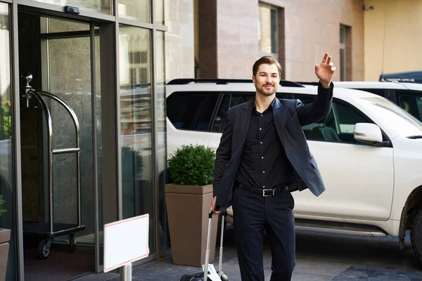 Cropped Picture Contented Guy Standing Building Greeting Someone Raised Hand — Stock Photo, Image