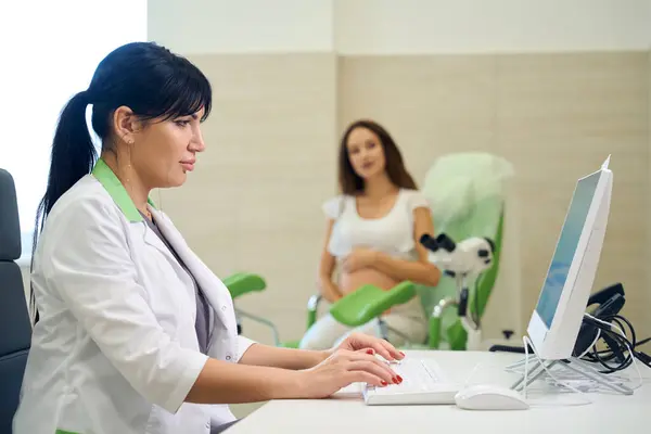 Vuxen Europeisk Kvinnlig Gynekolog Skriva Datorn Undersöka Suddig Gravid Kvinna — Stockfoto