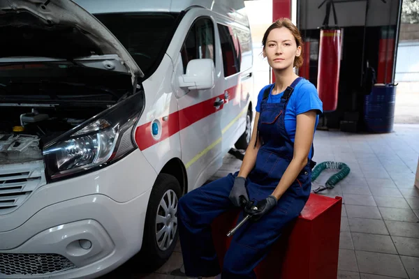 Young Woman Blue Uniform Sits Stand Special Car She Has — Stock Photo, Image