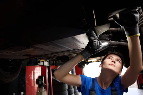Młody Mechanik Sprawdzający Podwozie Samochodu Warsztacie Samochodowym Kobieta Używająca Latarki — Zdjęcie stockowe