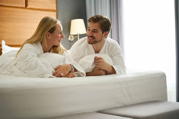 Woman Man Communicate While Lying Large Bed Wearing Hotel Terry — Stock Photo, Image