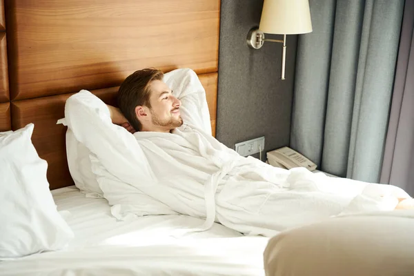 Young Man Resting Large Bed Male Fluffy Bathrobe — Stock Photo, Image