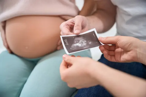 Close Man Holding Ultrasound Picture His Baby Wifes Womb Pregnant — Stock Photo, Image