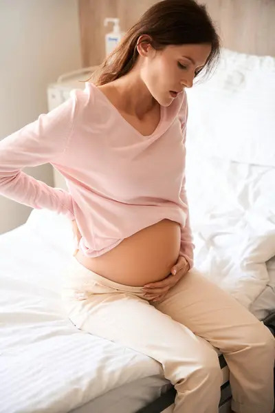 Kobieta Ciąży Bolesnym Skurczem Siedząca Oddziale Szpitalnym Dotykająca Brzucha — Zdjęcie stockowe
