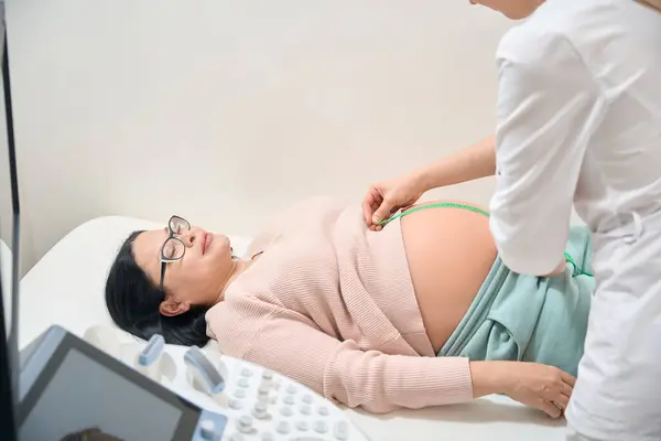 Vrouwelijke Gynaecoloog Die Lengte Van Buik Van Zwangere Vrouw Controleert — Stockfoto