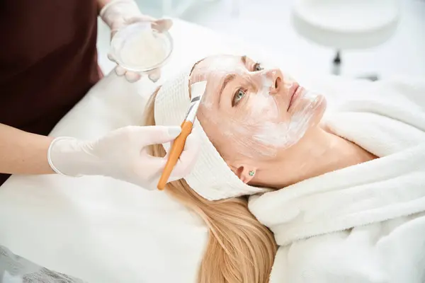 Woman Beautician Using Special Brush Apply Mask Clients Face Brightening — Stock Photo, Image