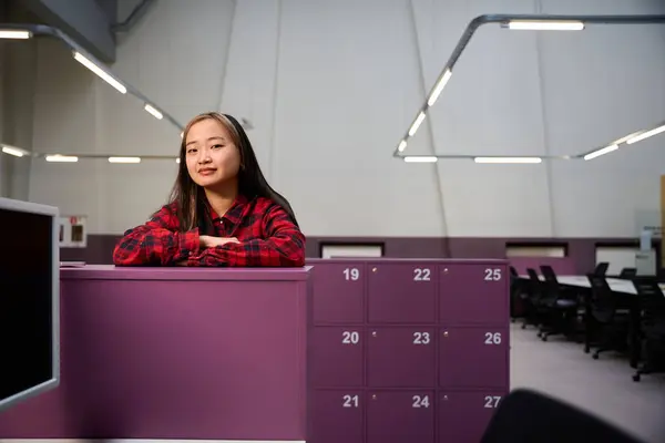 Young Serious Asian Female Employee Looking Camera Standing Cupboard Coworking — Stock Photo, Image