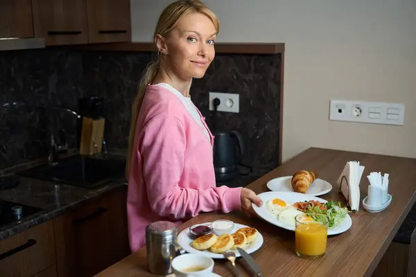 Joyous Young Woman Putting Ceramic Plate Breakfast Food Kitchen Table — Stock Photo, Image