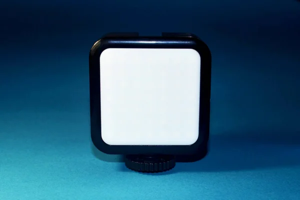 Small square camera lamp on a blue background