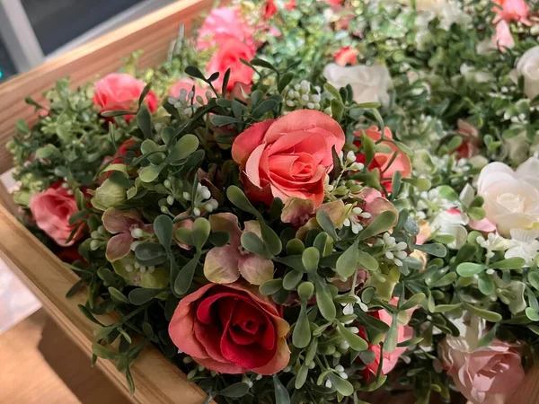 plastic flower decoration in a cute and aesthetic wooden basket. These colorful plastic plants are commonly used to sweeten the room. its shape like a living plant is very pleasing to the eye.